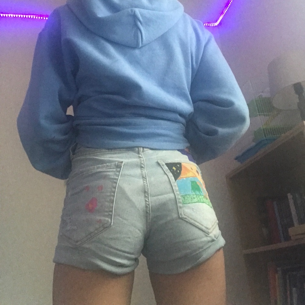 Light wash jeans. Abstract designs on the back